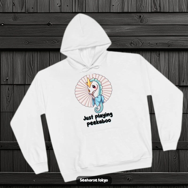 A cozy hoodie showcasing a charming seahorse in a blue kimono playfully peeking from behind a large fan, perfect for warm and humorous comfort.
